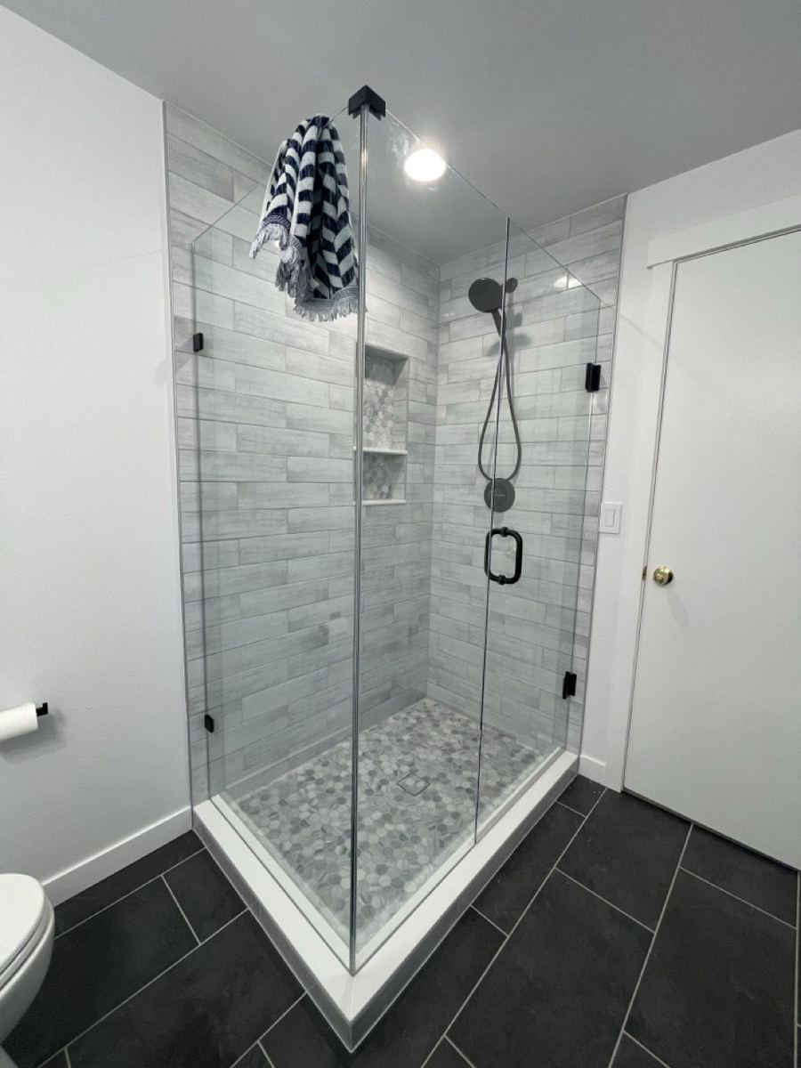 Corner glass shower with pebble floor