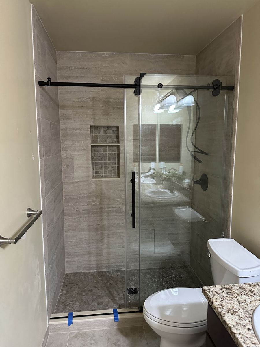 Walk-in shower with sliding glass door