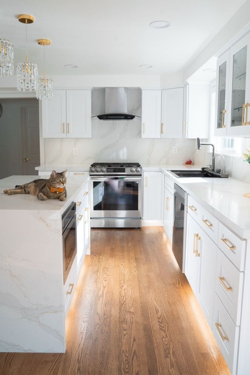 Galley kitchen with white cabinets
