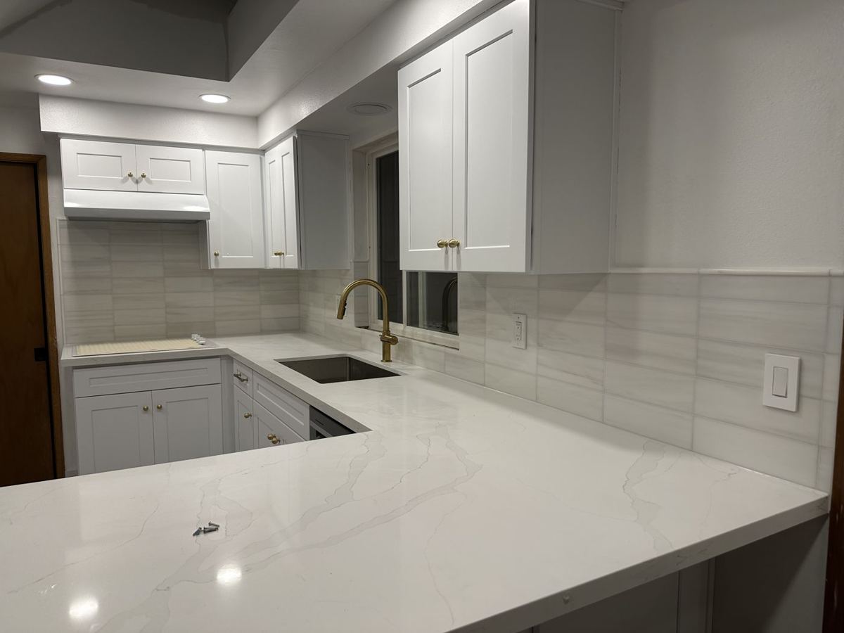 White cabinets with tile backsplash